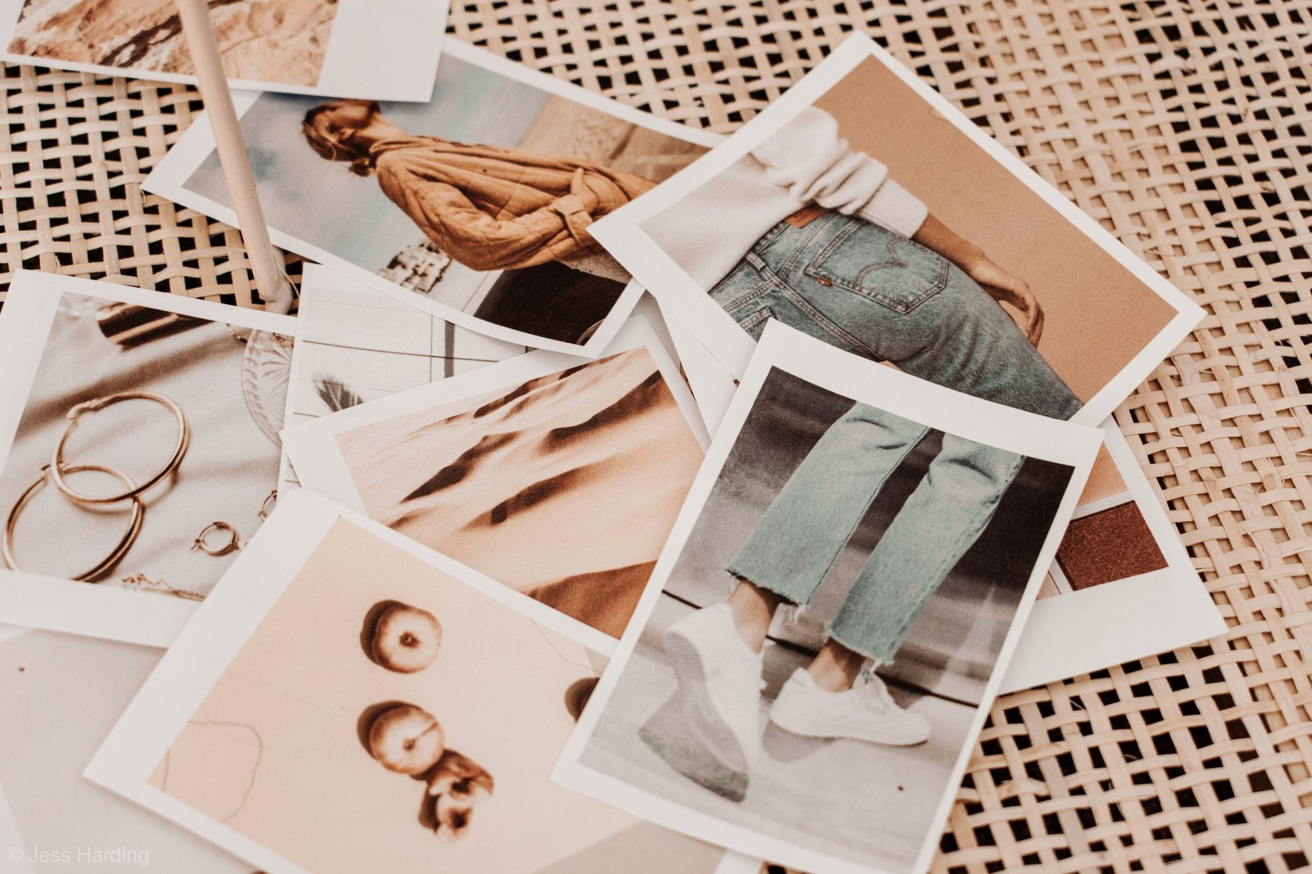 Bunch of instant photos of woman trendy outfits and accessories placed on table